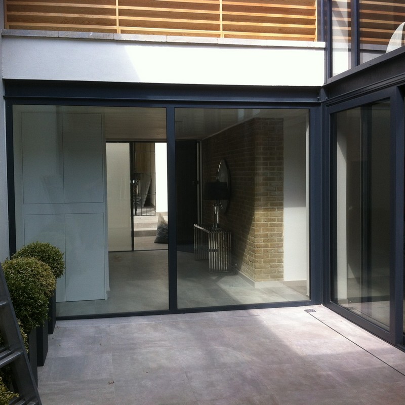 Floor-to-ceiling sliding doors opening to courtyard in Belgravia