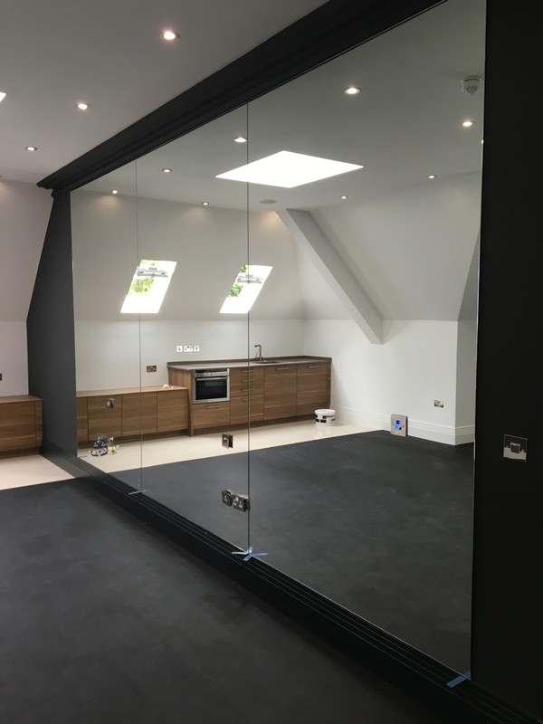 Frameless glass partition in loft conversion by Belgravia glaziers