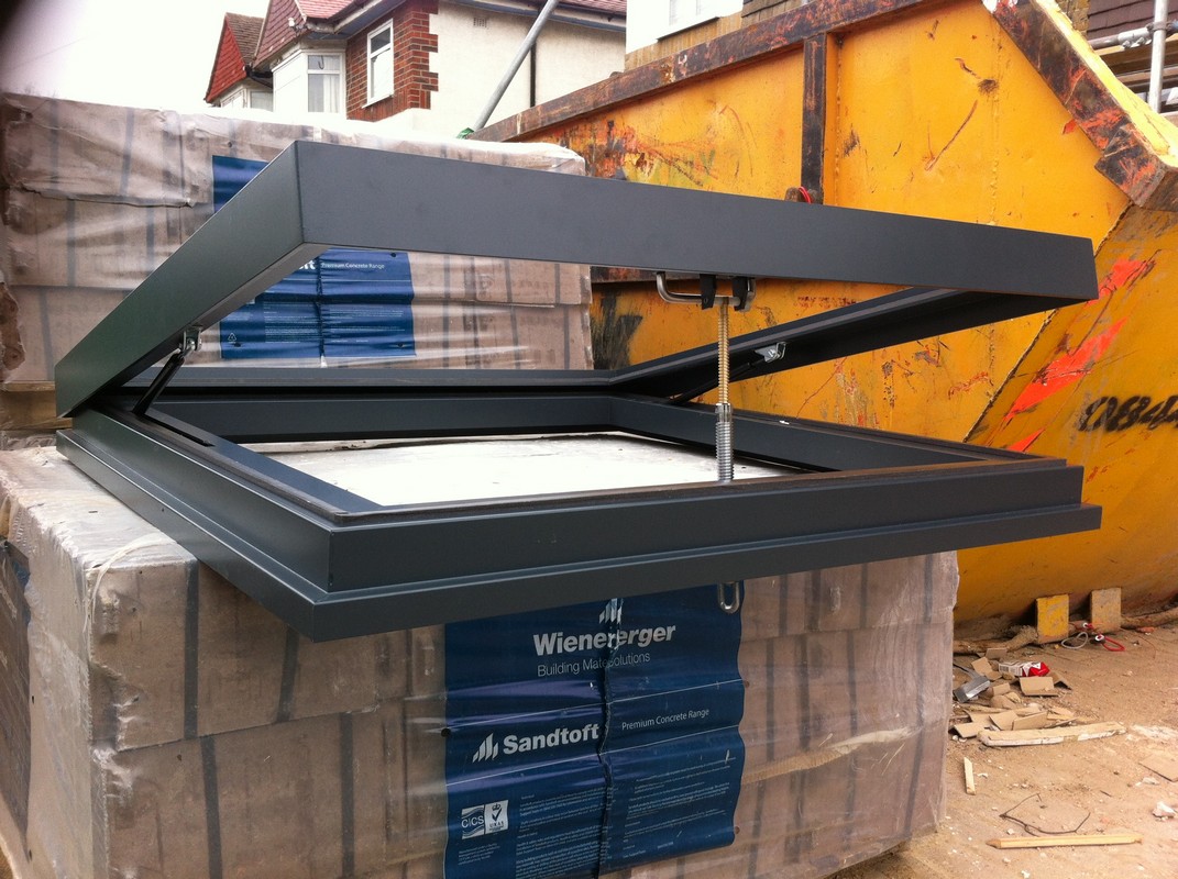 Opening flat roof skylight in anthracite grey installed in Belgravia